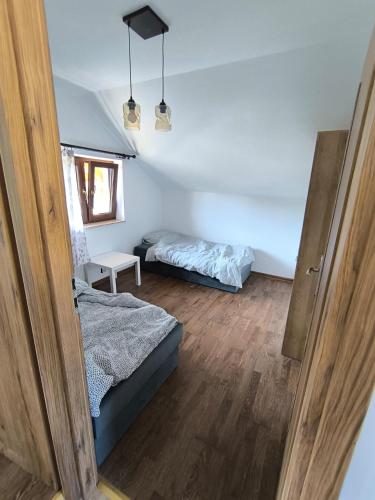 a small bedroom with a bed and a bed sqor at Lawendowo in Koniecpol