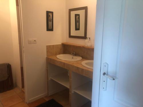 a bathroom with a sink and a mirror at Meadow Brook Gites in La Lande-de-Goult