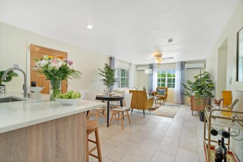 a kitchen and living room with a table and chairs at Relaxing Island Retreat Steps to Grace Bay Beach in Long Bay Hills