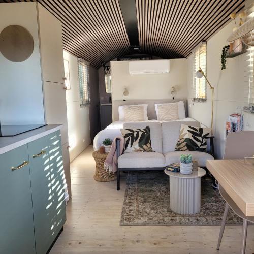 a living room with a bed and a couch at Boholodges 2 pers met privé hottub in Meerssen