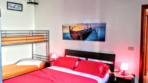 a bedroom with two bunk beds with red pillows at Casa Filomena in Ischia