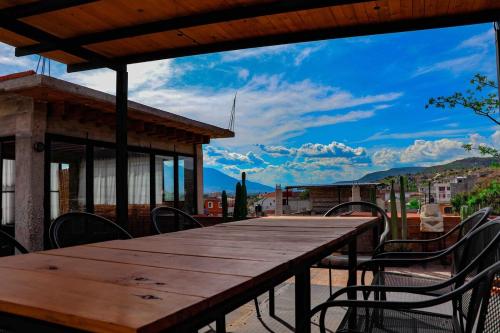 a wooden table and chairs on the roof of a building at Casa Aida in San Pablo Villa de Mitla
