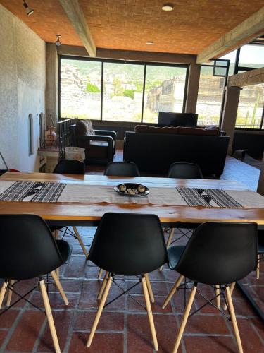 a conference room with a large wooden table and chairs at Casa Aida in San Pablo Villa de Mitla