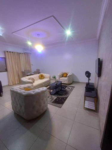 a living room with two couches and a tv at 2 bed room apartment in Lekki