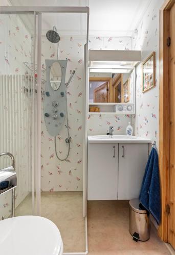 a bathroom with a shower and a sink at Sauna Apartment in Tromsø