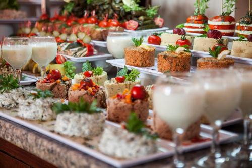 a buffet of desserts and wine glasses on a table at Crystal Hotel Bodrum in Gumusluk