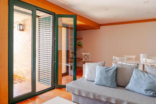 a living room with a couch and a patio at Casa S. José in Sesimbra