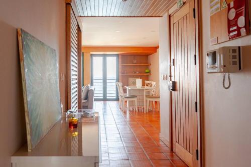 a living room with a table and a dining room at Casa S. José in Sesimbra