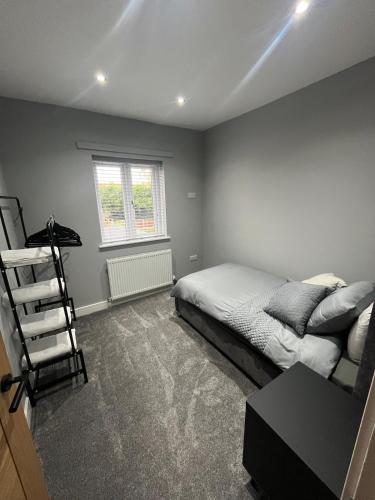 a bedroom with a bed and a chair in it at Galway Glamour in Bircotes