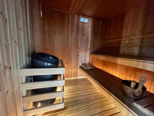 a wooden sauna with a blue bowl in it at Doncella Beach , apartamento con vistas al mar in Estepona