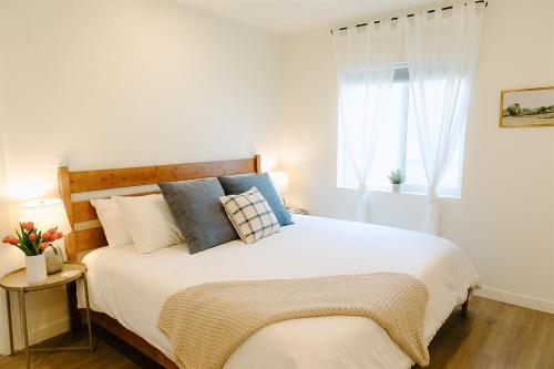 a bedroom with a large white bed with pillows at Cozy Downtown Havens in Moscow