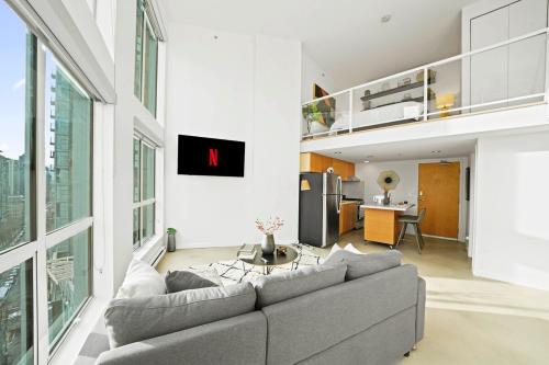 a living room with a couch and a table at The Urban Lofts in Vancouver