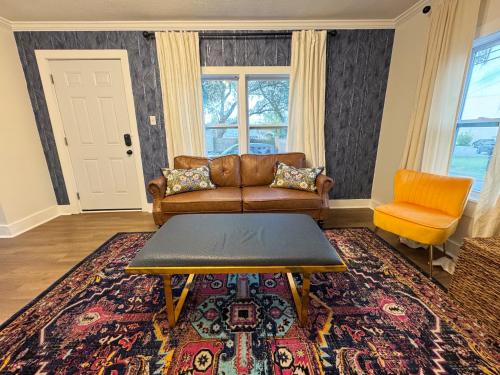 a living room with a couch and an orange chair at Dreami Stays Panama City - 2BR Retreat Near Downtown, Beaches, & Hot Spots in Panama City