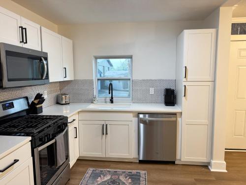 a kitchen with white cabinets and a stove top oven at Dreami Stays Panama City - 2BR Retreat Near Downtown, Beaches, & Hot Spots in Panama City
