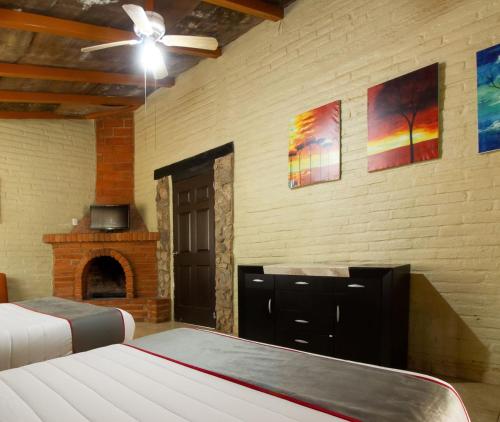 a bedroom with two beds and a ceiling fan at Taanah Glamping in Zapotlanejo