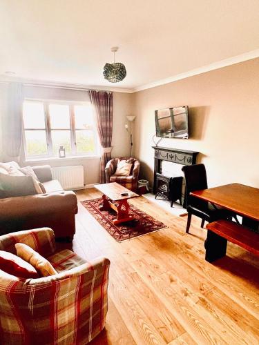 a living room with a couch and a fireplace at 3 Bedroom harbourside apartment, Queensferry, 10 miles from Edinburgh in Queensferry