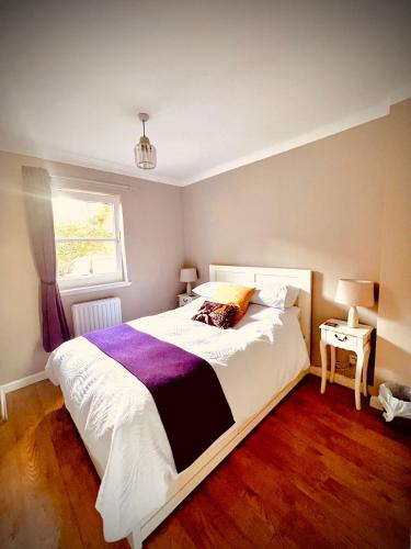 a bedroom with a large bed and a window at 3 Bedroom harbourside apartment, Queensferry, 10 miles from Edinburgh in Queensferry