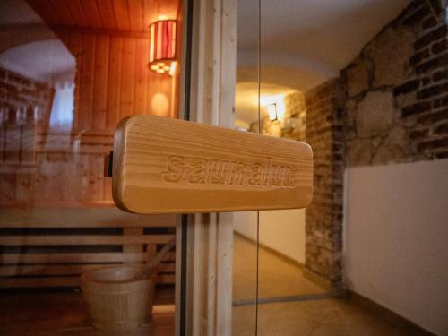 a wooden sign on a door in a room at Na Uboczu in Gryfów Śląski