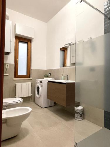 a bathroom with a sink and a washing machine at Dimore del Sud in Trani