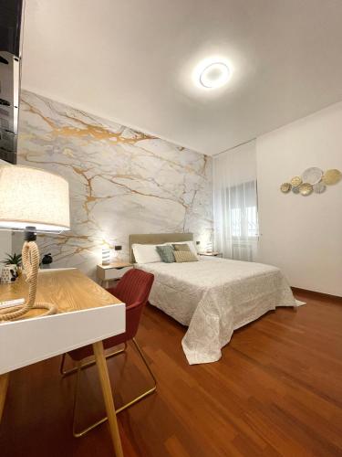a bedroom with a bed and a marble wall at Dimore del Sud in Trani