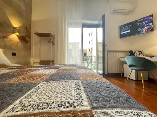 a bedroom with a large bed with a blue chair at Dimore del Sud in Trani