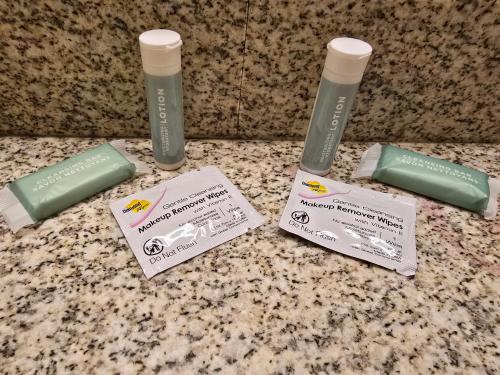 a counter with two bottles of toothbrushes and certificates at Country Inn & Suites by Radisson, Convention Center in Altoona