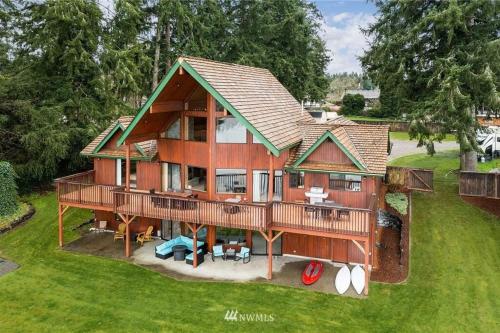an overhead view of a home with a large deck at Beautiful Private Lake Lodge with Private Dock and Mountain Views in Spanaway
