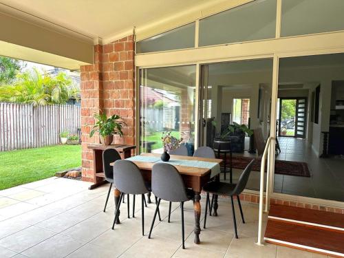 a dining room with a table and chairs at Driftwood Dream - Tweed Coast Holidays in Pottsville