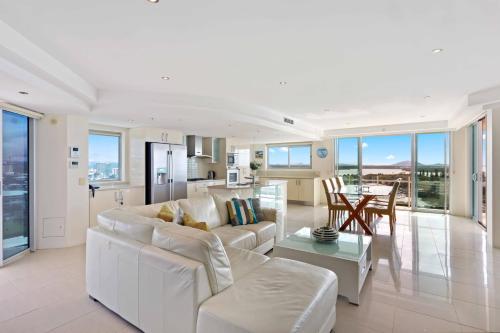 a living room with a white couch and a table at Aqua Vista Resort in Maroochydore
