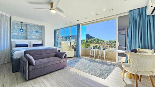 a bedroom with a bed and a couch at Waikiki Grand Hotel Official Site in Honolulu