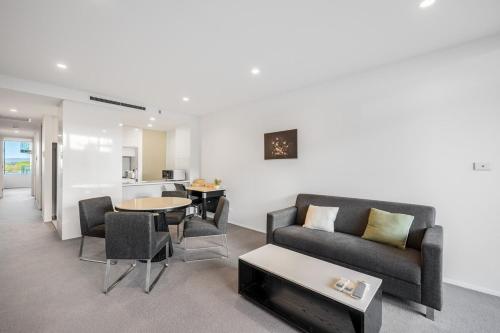 a living room with a couch and chairs and a table at Lakefront Modern 2 BDR Apartment with 2 Parking Kingston in Kingston