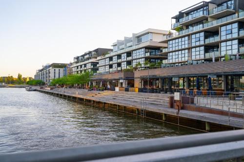a dock next to a body of water with buildings at Lakefront Modern 2 BDR Apartment with 2 Parking Kingston in Kingston