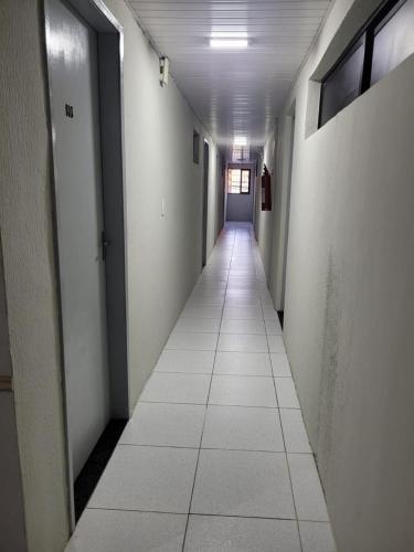 an empty hallway with a long corridor at Sol do Centro Pousada in Fortaleza