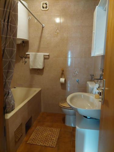 a bathroom with a sink and a tub and a toilet at Apartments with parking space Postira, Brac - 700 in Postira