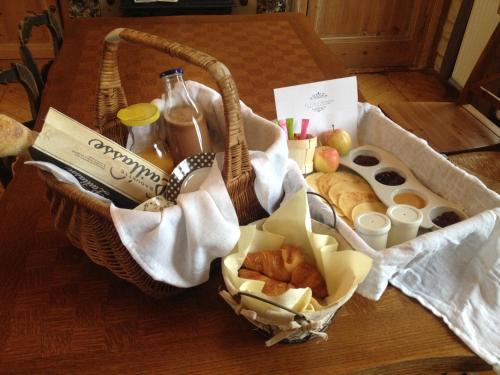 a basket of bread and pastries on a table at Le Clos Charmaine in Auquemesnil
