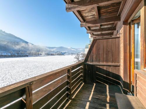 a wooden balcony with a view of a snow covered field at Brixen Alpin Living Top 2 in Brixen im Thale