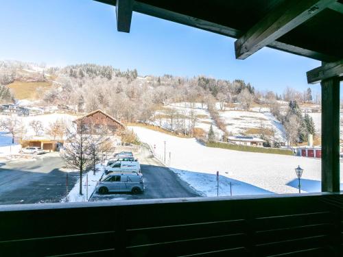 a view of a parking lot with cars parked in the snow at Brixen Alpin Living Top 5 in Brixen im Thale