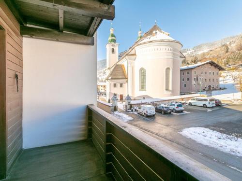 a balcony with a view of a church and a street at Brixen Alpin Living Top 5 in Brixen im Thale