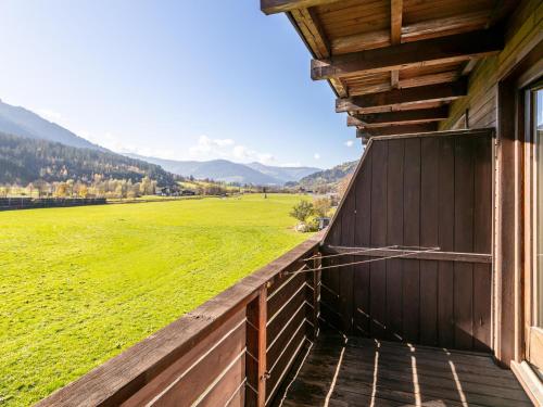 a view from the porch of a barn with a green field at Brixen Alpin Living Top 13 in Brixen im Thale
