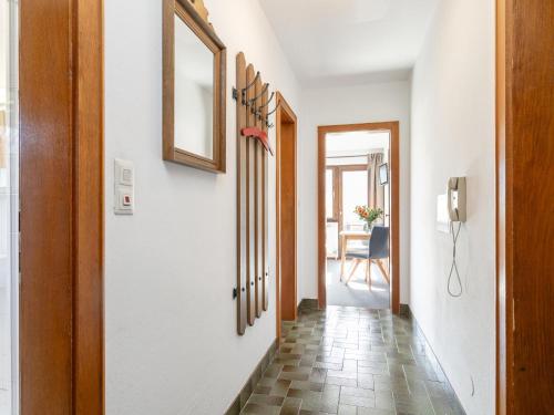 a hallway with a door and a table at Brixen Alpin Living Top 13 in Brixen im Thale