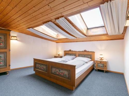 a bedroom with a bed and a skylight at Brixen Alpin Living Top 16 in Brixen im Thale