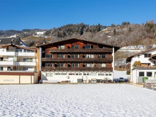 a large building on a beach with a mountain at Brixen Alpin Living Top 16 in Brixen im Thale