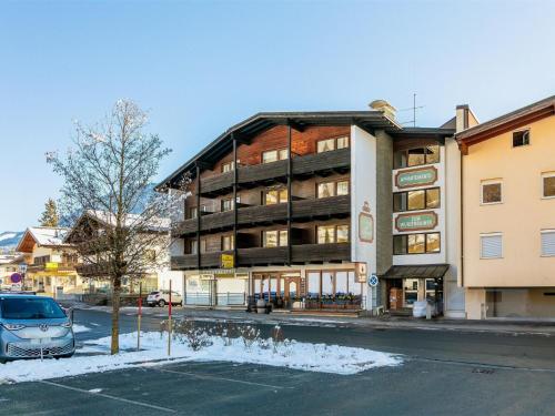 a building on the side of a street with a parking lot at Brixen Alpin Living Top Alle in Brixen im Thale