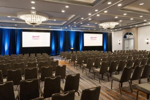 a conference room with chairs and two screens at Marriott Jacksonville in Jacksonville
