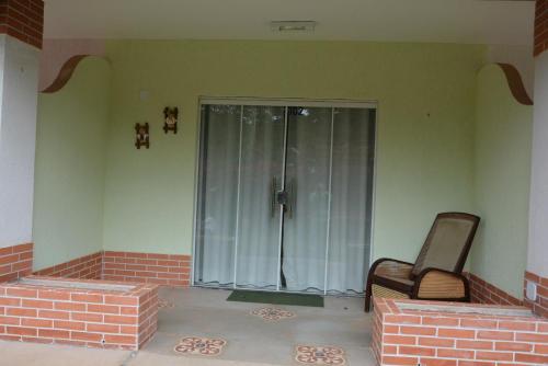 a room with a sliding glass door with a chair at Pousada Gruta in Ubajara