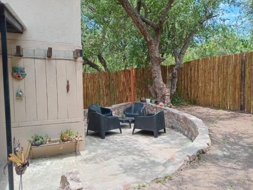 a patio with chairs and a table next to a fence at Casa wairaluna in Capilla del Monte