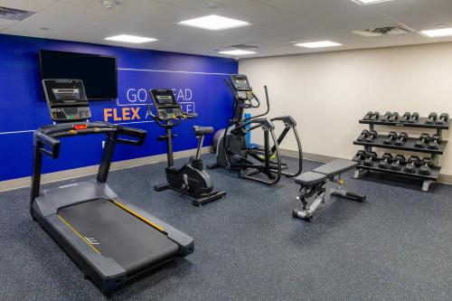 a gym with several treadmills and cardio machines at Holiday Inn Express - Neptune by IHG in Neptune City