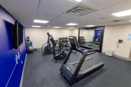 a gym with treadmills and exercise equipment in a room at Holiday Inn Express - Neptune by IHG in Neptune City