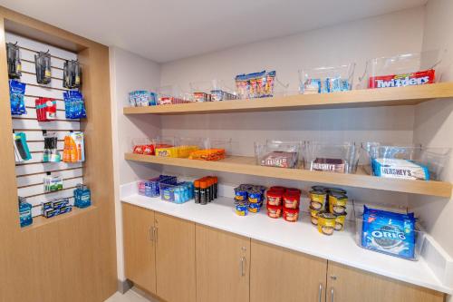 a walk in pantry with shelves filled with food at Holiday Inn Express - Neptune by IHG in Neptune City