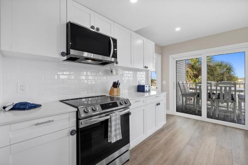 a kitchen with white cabinets and a stove top oven at Chadwick Cove Marina in Englewood